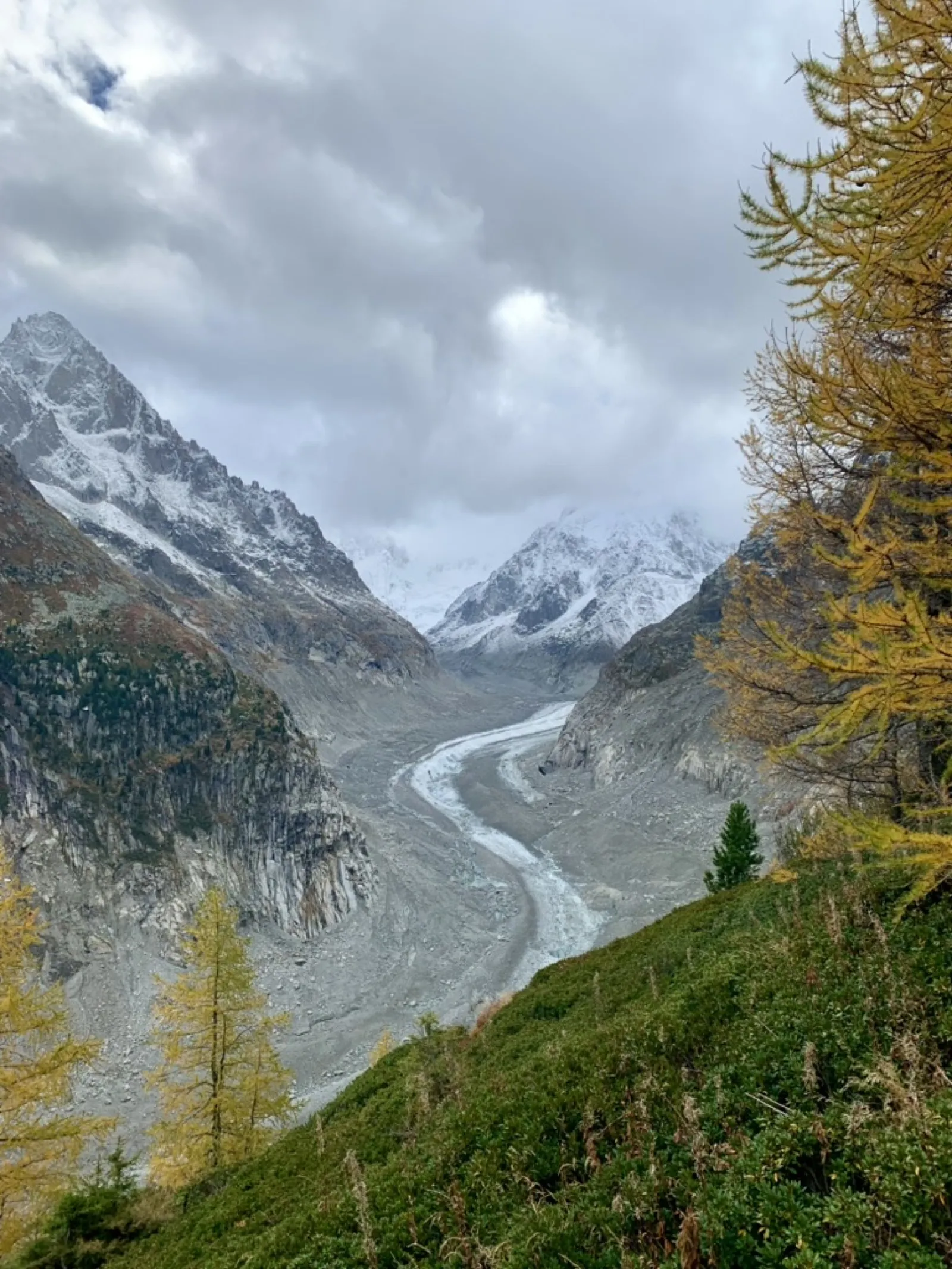 Winding glacial river through snow-capped mountain valley