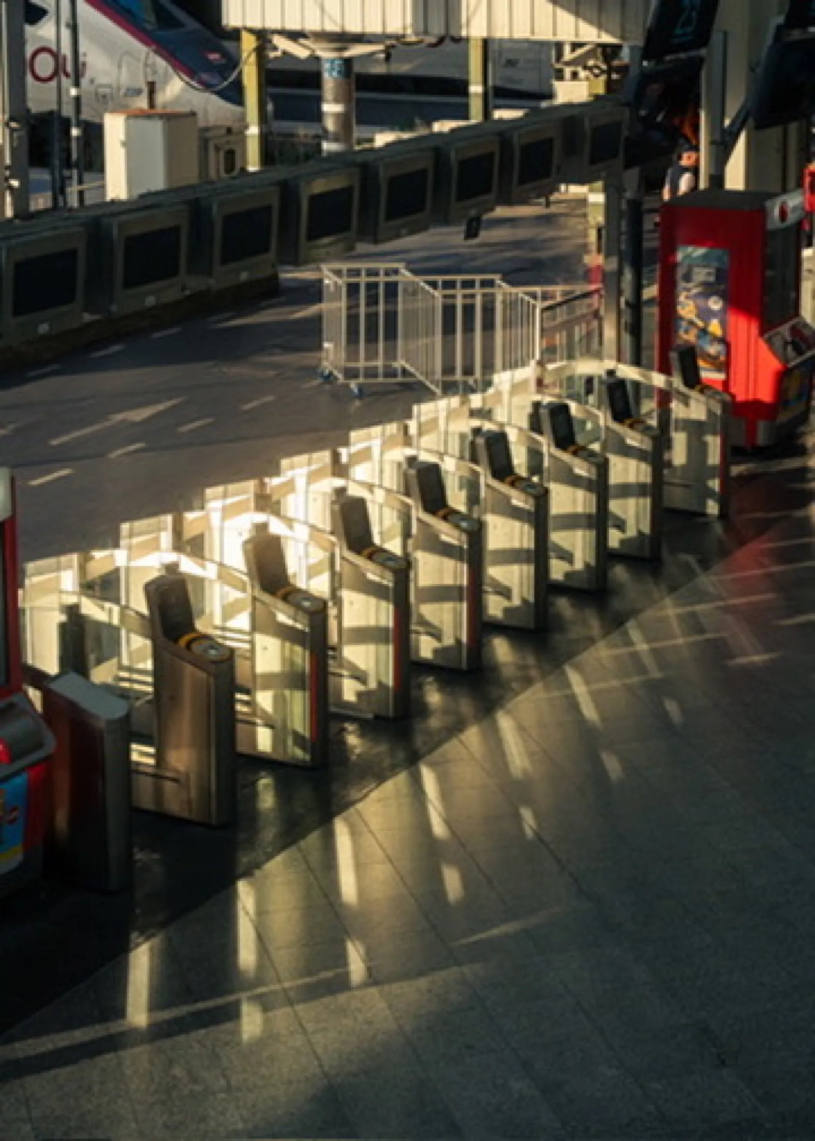 Sunlit metal barriers and empty urban plaza