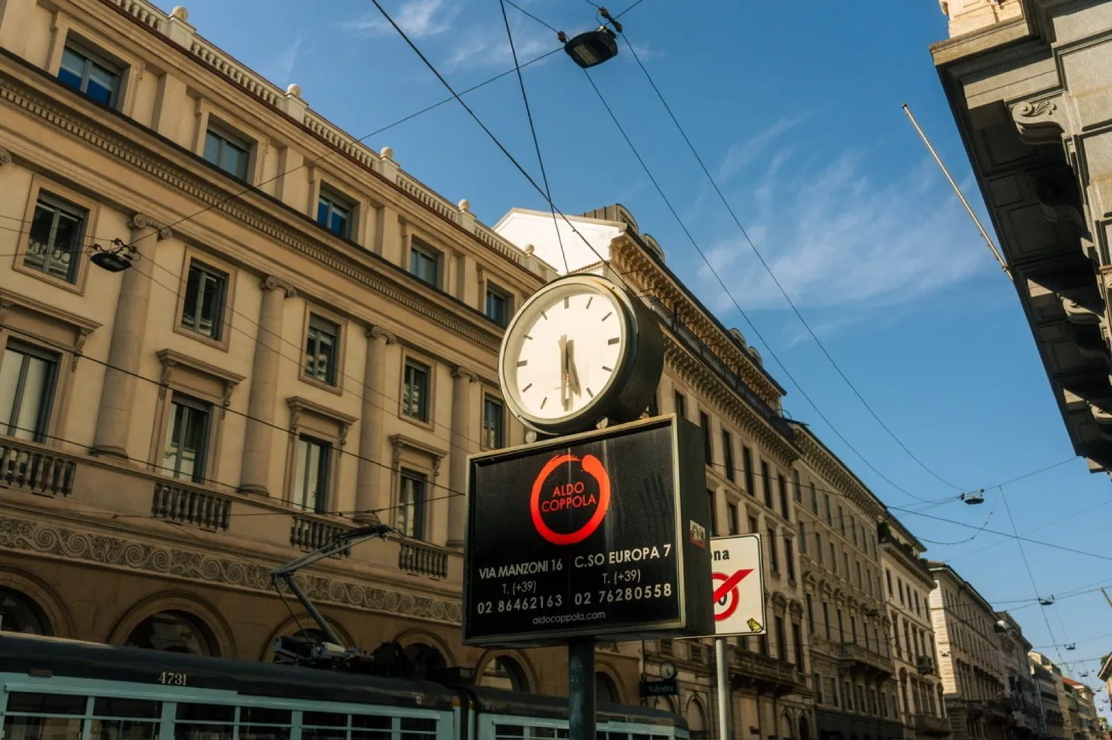 Historic clock and red storefront on European street