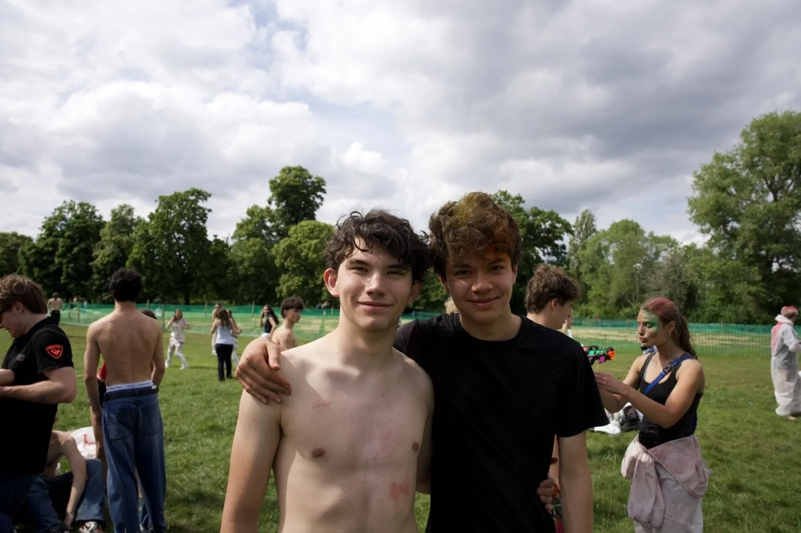 Two teenagers smiling at sports field event