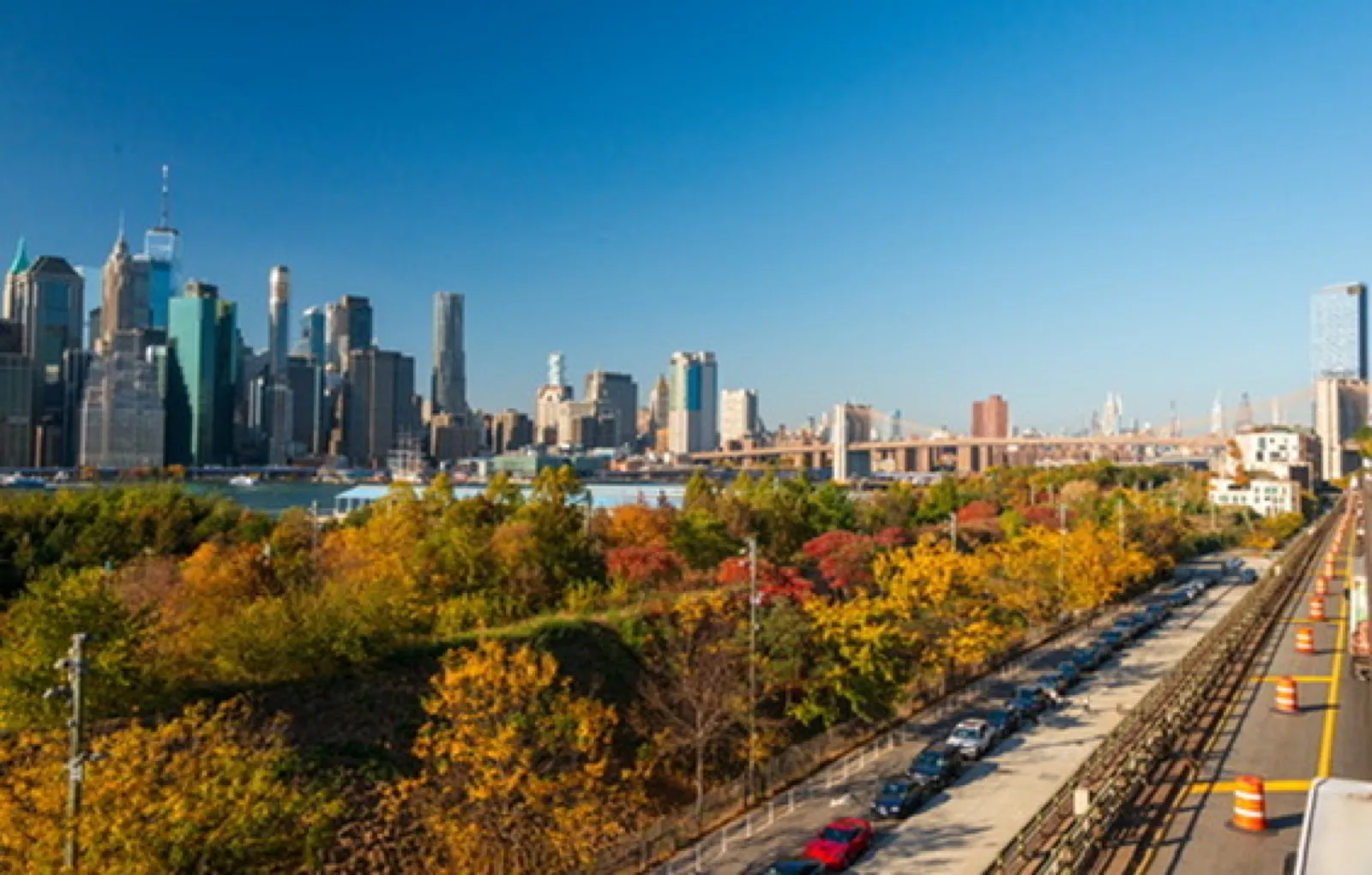 City skyline with autumn foliage and river
