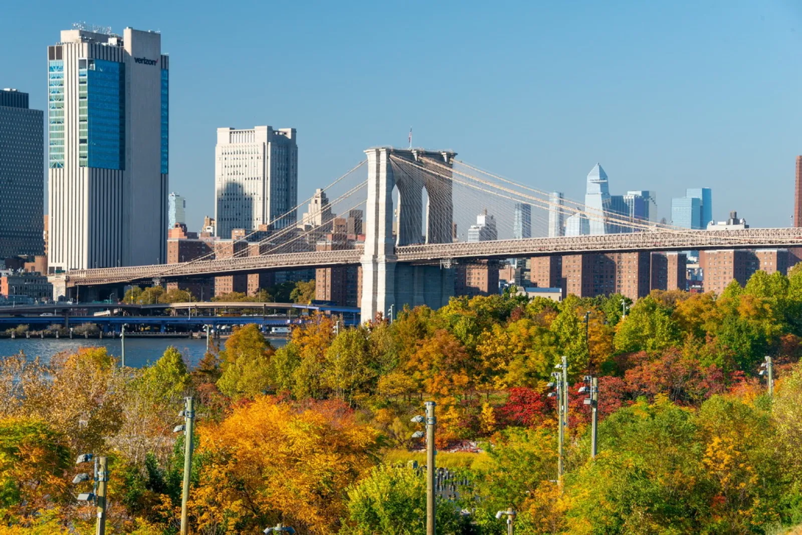 Bridge spanning river with autumn foliage