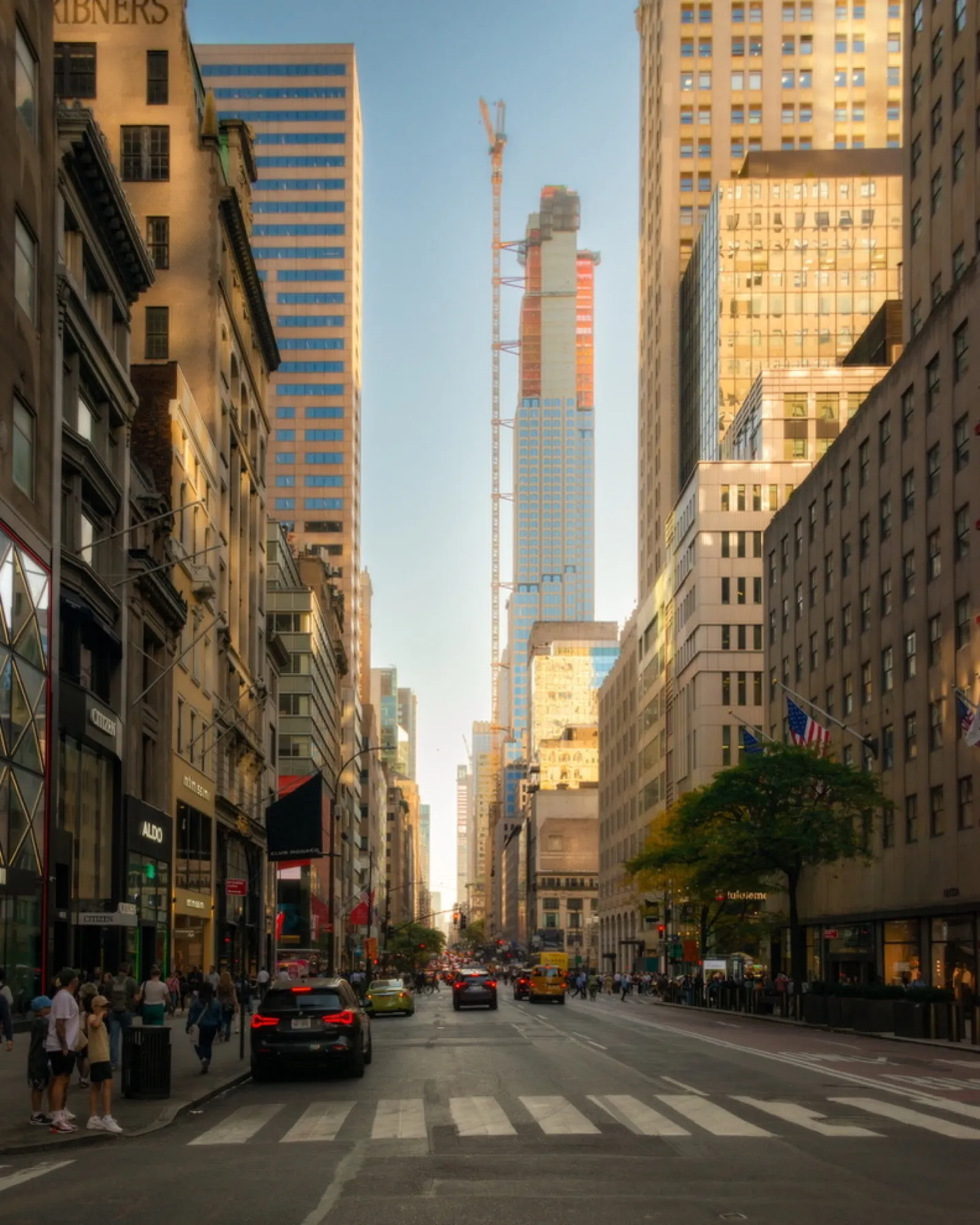 Busy street with towering skyscrapers and pedestrians
