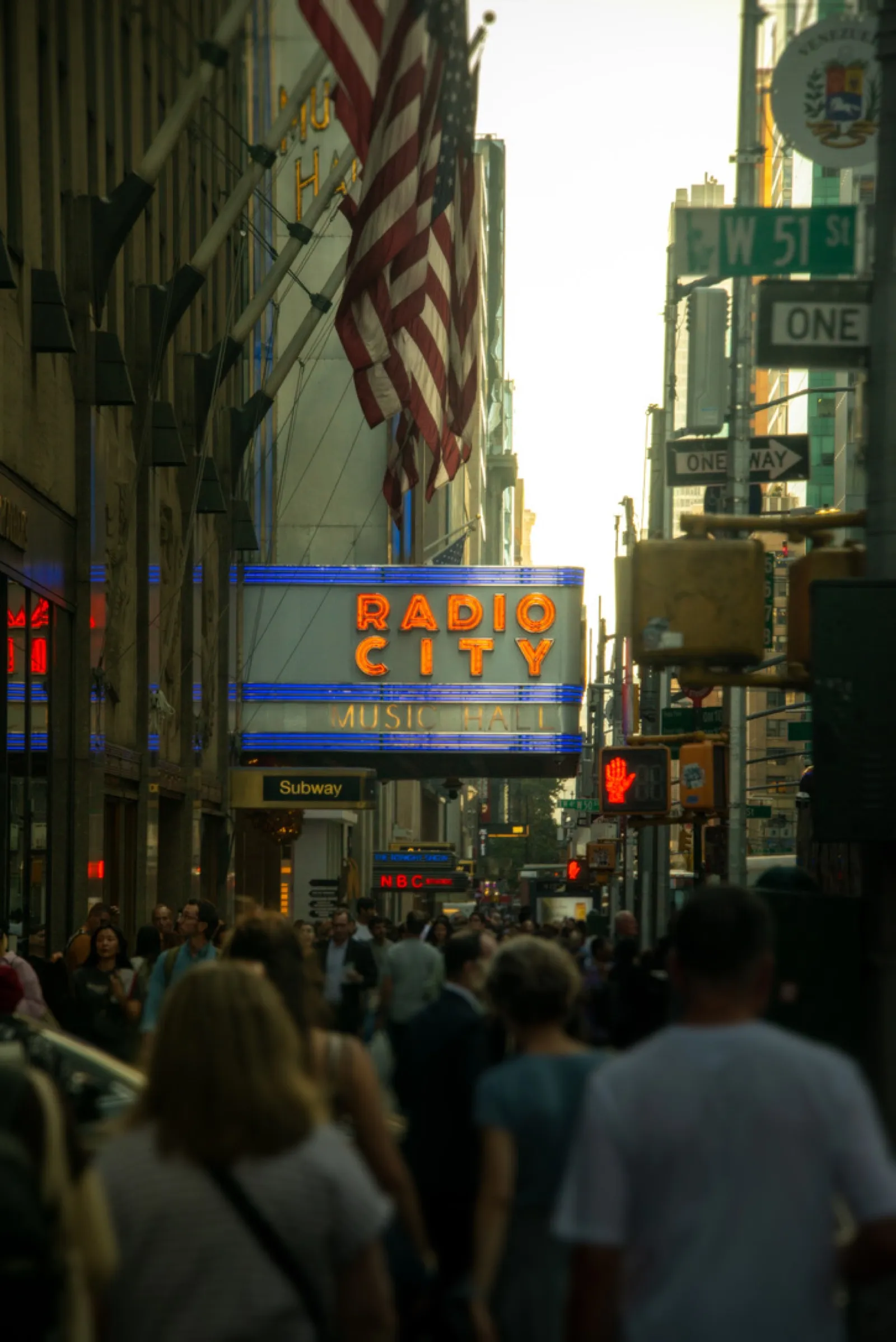 Radio City Music Hall neon sign in crowded street