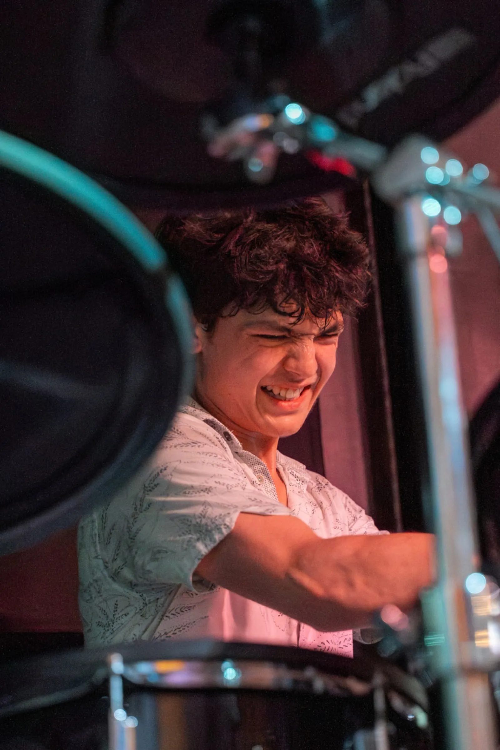 Smiling drummer performing at concert venue