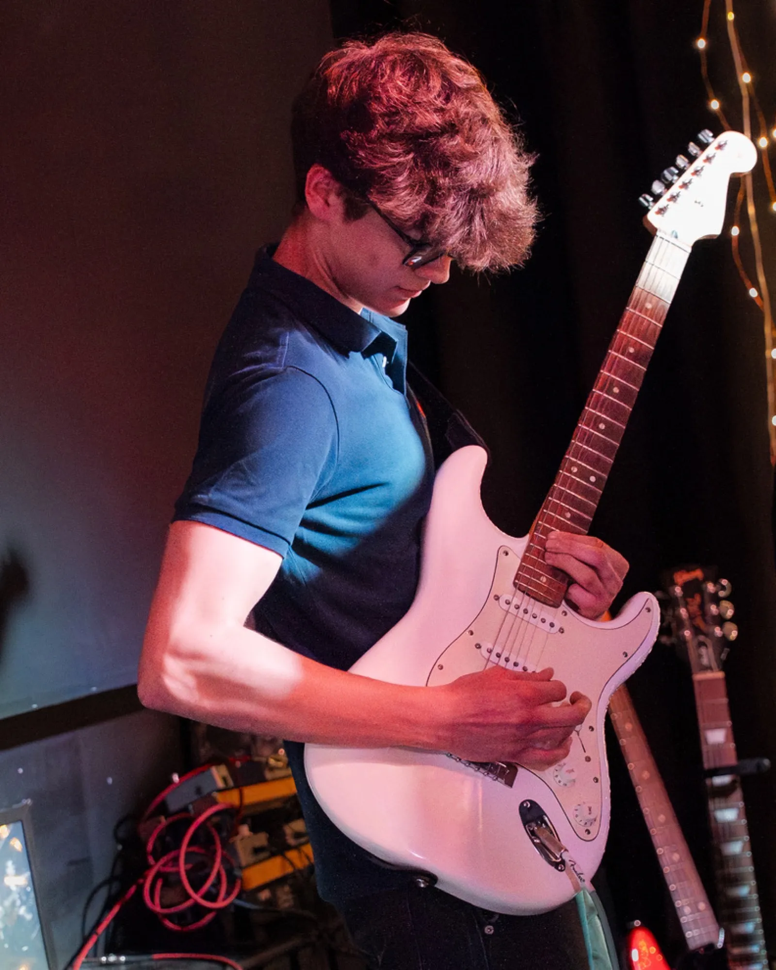 Guitarist concentrating while playing electric guitar
